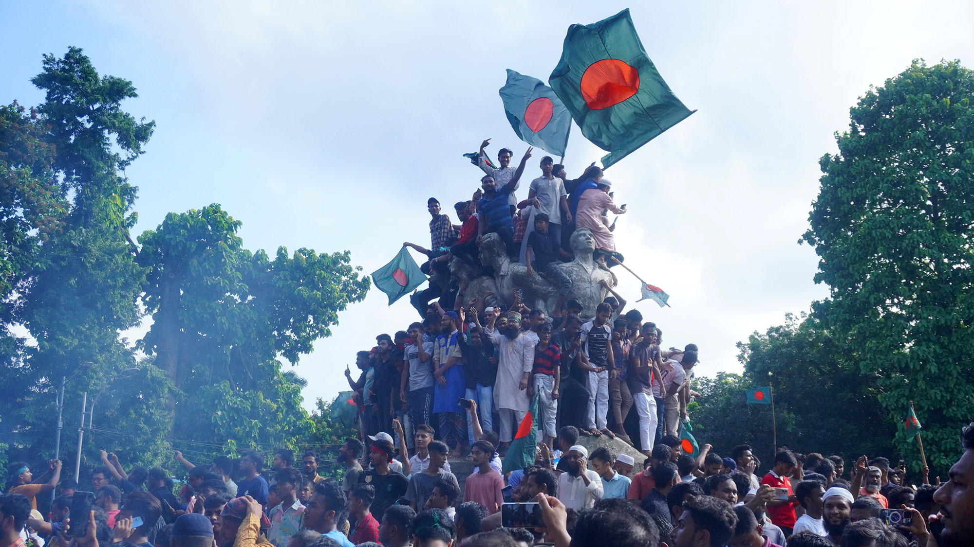 শেখ হাসিনার পতনের পর রাজু ভাস্কর্যকে ঘিরে মানুষের উল্লাস। ৫ আগস্ট ২০২৪। ছবি: সুদীপ্ত সালাম
